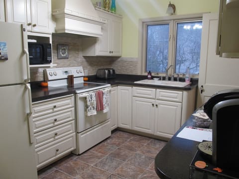 Kitchen with full stove and refrigerator
