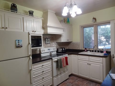 Kitchen with full stove and refrigerator
