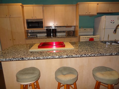 Kitchen with full stove and refrigerator