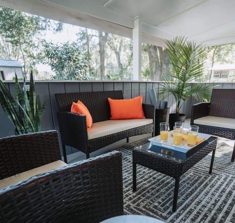 Outdoor living, elevated. Kick back on the wicker sectional and soak in the lush garden views.