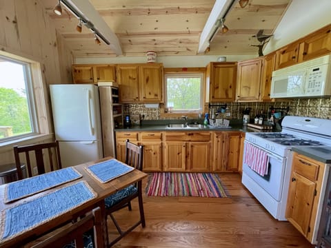 Kitchen with full size refrigerator, gas oven/stove, modern appliances.