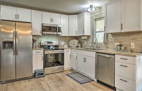 Kitchen with granite counter tops, stone backsplash and stainless appliances
