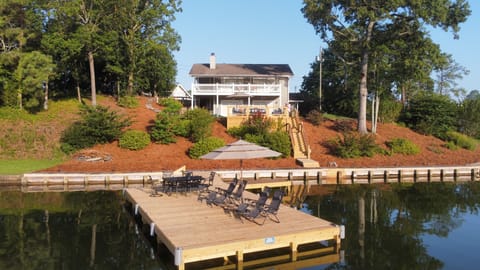 View of private dock, deck and home. 