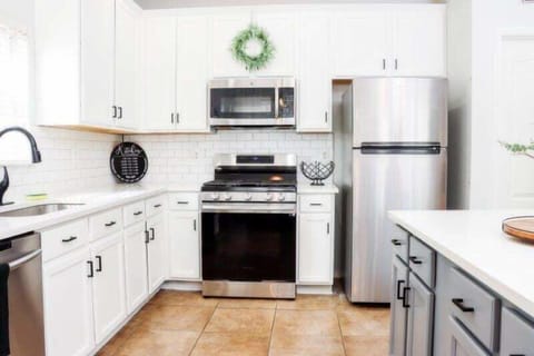 The kitchen boasts a beautiful island and sleek stainless steel appliances in an open-concept layout.