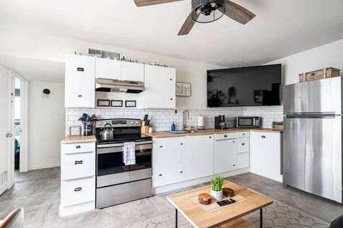 Kitchen: Modern appliances and chic decor invite culinary adventures in Tucson`s vibrant setting!