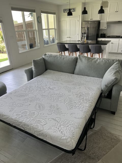 Couch bed downstairs with a queen memory foam mattress, and extra sheets. 