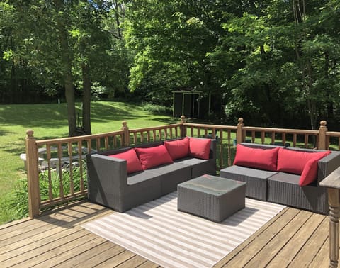 Back deck area for outdoor relaxation. Private, surrounded by trees. 