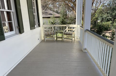 A spacious porch features 4 comfortable chairs for visiting.