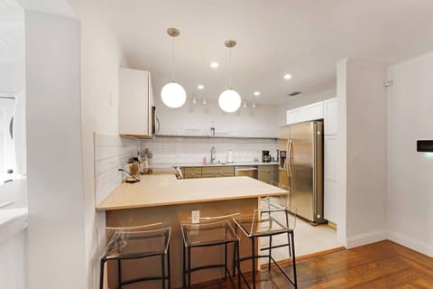 Kitchen is equipped with essentials - refrigerator, cooking stove, microwave, oven, coffee maker, etc. Plus we have 3 bar height chairs on the breakfast nook.