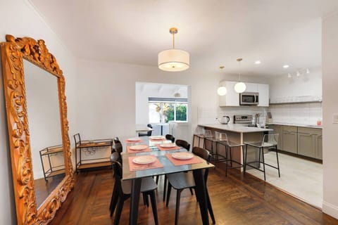 Dining area has a huge beautiful decorative mirror. 