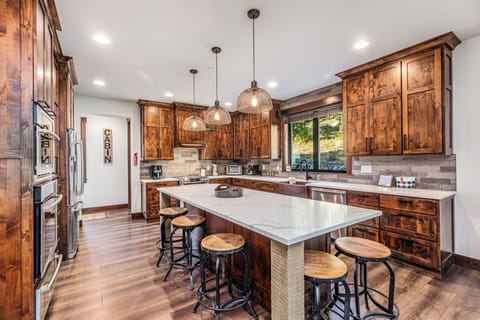 Chef’s Kitchen With Slab Island, Bar Seating And Viking Appliance Suite