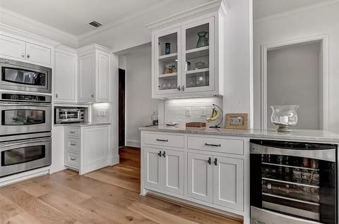 double ovens, wine refrigerator & bar area