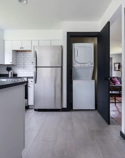 Newly renovated kitchen with a standing washer/dryer combo. 