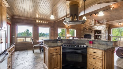 Full kitchen; Island with oven & stove located on main floor