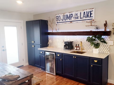 Our bar feature a beverage center, coffee bar, pantry, led lights, sink.