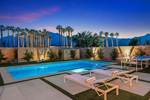 Palm-lined pool glowing at dusk, perfect for evening swims under colorful skies