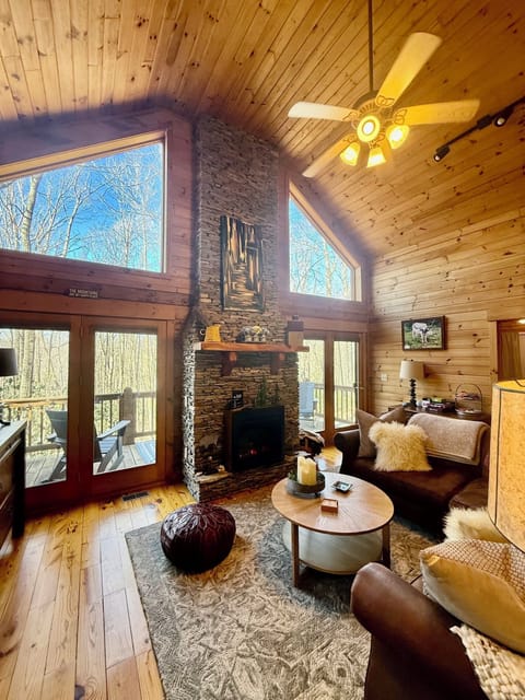 Cozy up in front of the soaring fireplace on the comfortable couch.