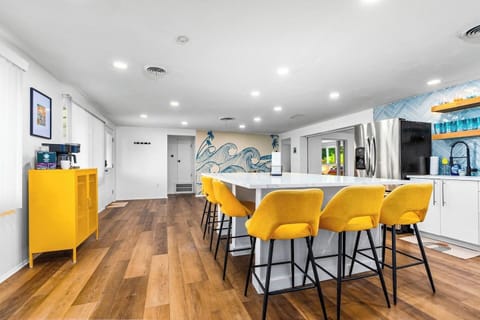 Newly remodeled kitchen with full slab quartz countertop, seating for 8.