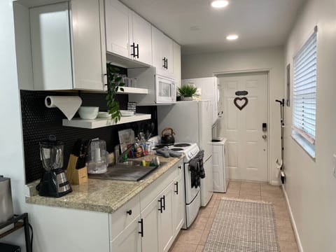Kitchen also contains washer and dryer.