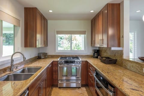 Sunlit kitchen offering scenic outdoor views and cozy ambiance.