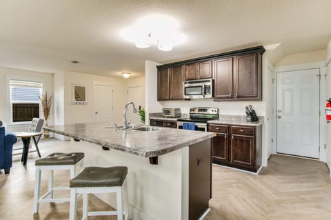 For additional seating, take advantage of the two stylish barstools at the kitchen counter.