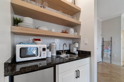 The kitchenette is equipped with granite countertops, a Keurig coffee maker, toaster, microwave, and bar refrigerator.