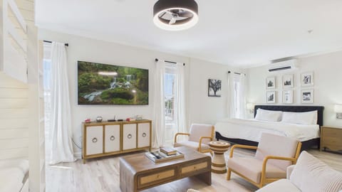 Huge TV in living area with stylish decor and furnishings about