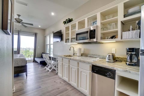 Kitchenette with cook top, fridge and microwave.