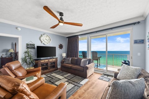 Stretch out in your spacious living room where the stunning sea view greets you through floor-to-ceiling windows. Relax on plush seating as coastal breezes circulate overhead, making every moment feel like a true beachfront escape.