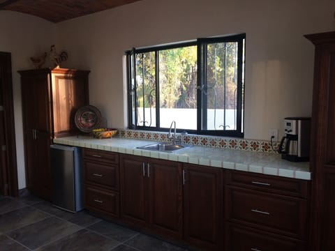 Kitchen with bar fridge and coffee maker