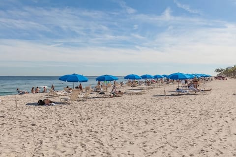 Unwind under sunny umbrellas with easy beach days ahead.