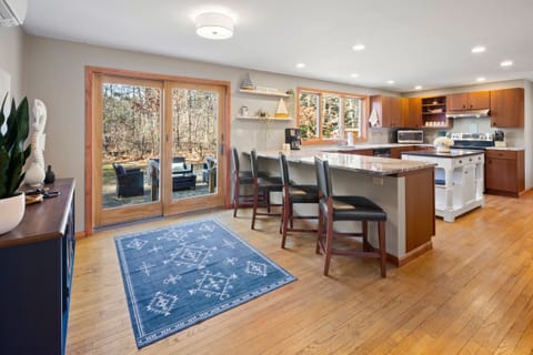 Barstools on the peninsula and large slider to the back patio