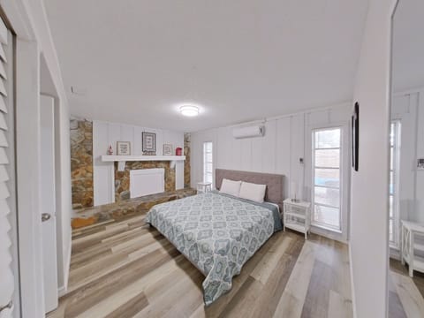 Bedroom with king size bed and an AC: split type ductless system