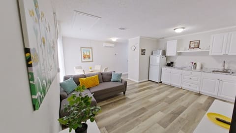 Open Concept Living Area with flat TV, couch & AC:  split type ductless system.