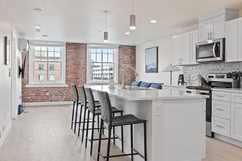 Sleek, fully stocked kitchen with high-end appliances—perfect for home-cooked meals or morning coffee.