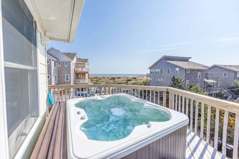 A cozy four-person hot tub, ideal for warming up and relaxing on chilly nights under the stars.