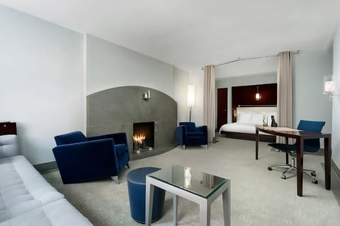 Unwind by the glowing fireplace in this spacious suite bedroom.