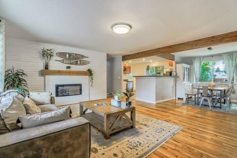 Bright, open living area with a cozy fireplace and plenty of room to lounge, flowing right into the kitchen and dining space for easy hangouts.