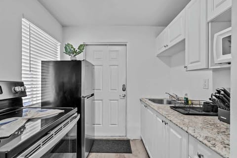Cook up comfort in this compact kitchen with granite counters, coffee maker, and full-size fridge—ideal for extended stays.


