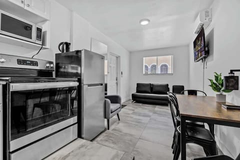 Whip up meals with ease in this sleek kitchen featuring granite counters, coffee maker, and microwave.

