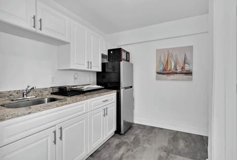 Whip up meals in this sleek kitchen featuring stainless steel appliances, granite countertops, and all the essentials for your vacation rental experience.