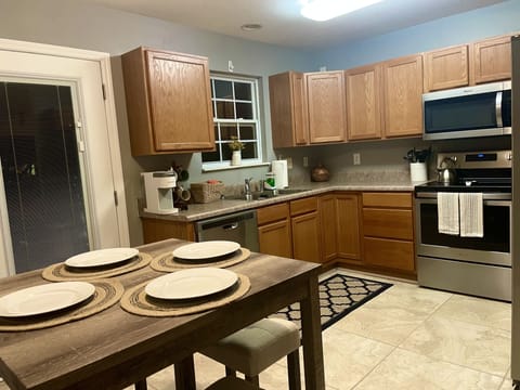 Kitchen w/ access to Patio. All new appliances and views of trees and greenery