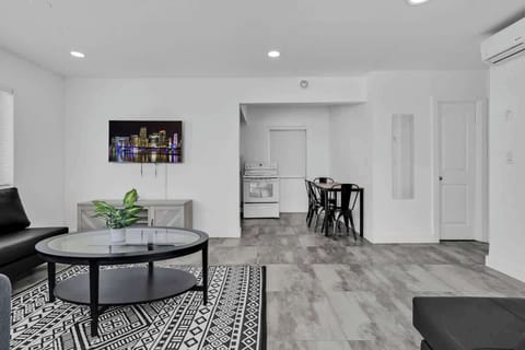 Open-concept living and dining area with smart TV and cozy furnishings—great for couples or small groups.