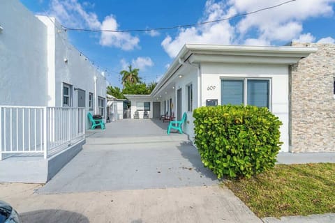 Relax outside your private unit with colorful chairs and tropical vibes—perfect for a laid-back stay.