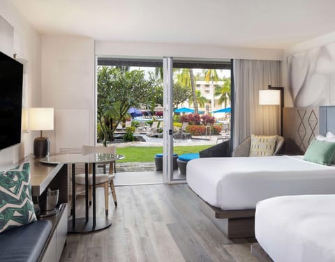 Step outside to tropical grounds from your airy room.