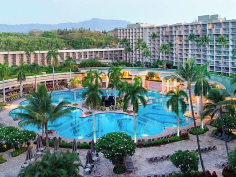 Dream big with sweeping resort pool views framed by palms.