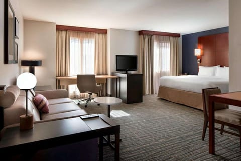Sink into a plush bed after relaxing in the bright suite.