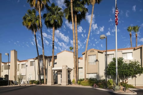 Arrive with ease at a bright, palm-lined entrance.