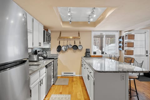 Updated kitchen with stainless steel appliances and breakfast bar.