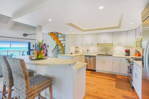 Modern chef`s kitchen offering a center island and premium appliances.